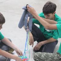 Students create a parachute for their egg for Physics Olympics